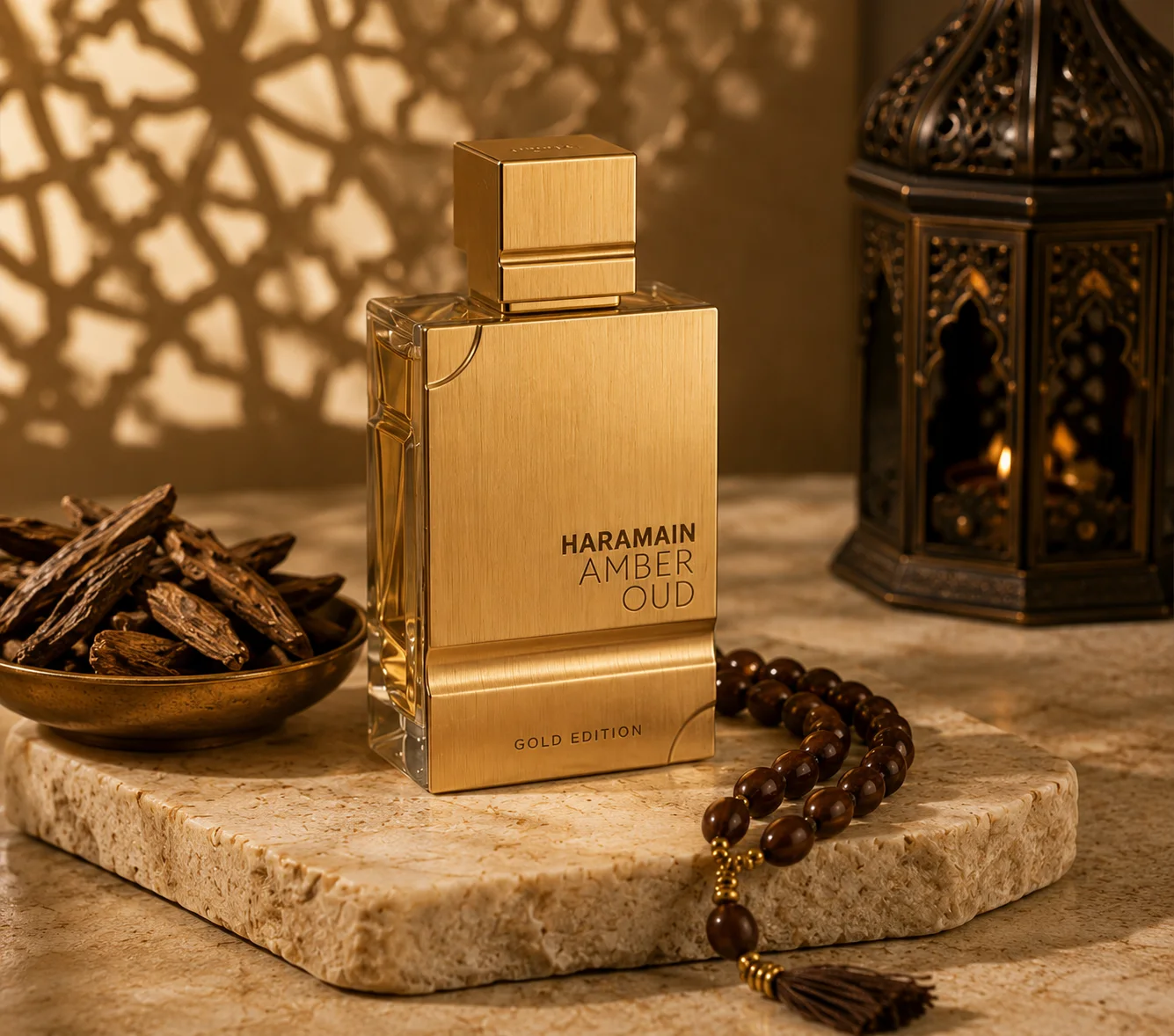Amber oud fragrance beside carved lantern and oud wood